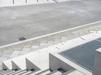 the skateboarder is riding down the concrete steps beside his boarder on the pavement