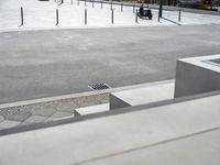 the skateboarder is riding down the concrete steps beside his boarder on the pavement