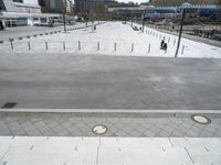 a concrete plaza in a park with lots of bricks around it, including two benches and a fire hydrant