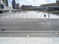 a concrete plaza in a park with lots of bricks around it, including two benches and a fire hydrant