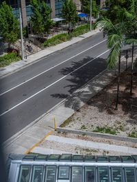 a long bus is traveling down the street by itself and it looks like he's going to work