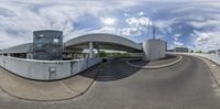 a big wide angle view of an airport entrance under the bridge over the freeway as if it were on a boat