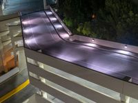 a view of a road and an overpass with traffic passing through it by buildings