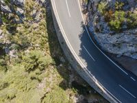 view of an aerial photograph from above, from the air of a car driving on a road