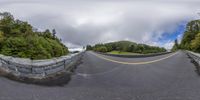 a 360 - lens fisheye lens shot of the road that goes over to the mountain