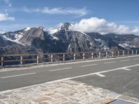 there is a picture of a mountain with a bike on it and people walking along the side of the road