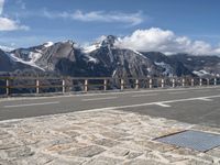 there is a picture of a mountain with a bike on it and people walking along the side of the road