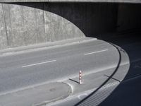 a red and white stop sign sitting under a tunnel on the side of a road