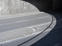 a red and white stop sign sitting under a tunnel on the side of a road