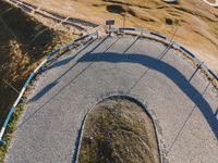 this is an image of a curved road and a sign that reads bj's and fs