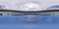 a tennis court with several empty stands in it and clouds overhead them at the ball