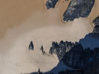 some large mountains are covered in snow and sand as seen from the air by a bird's eye view