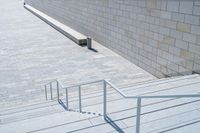 a person that is on some stairs with a skateboard in handrails at the top of a set of stairs