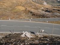 the view of an empty winding road in a mountainside, as seen from the air