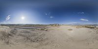 the view from underneath the large fisheye lens looking at a dirt area with a road in the foreground