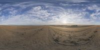 the view from inside of a fisheye lens of a field with dirt in the foreground