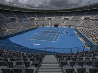 tennis court in empty stadium with a cloudy sky in the background area at the top