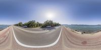 a fish eye view of a beach road and the ocean in the background are three separate images