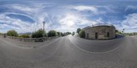 a fisheye view of the road and buildings from below in an urban setting with blue sky