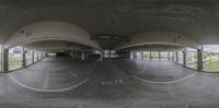 a 360 view of an empty parking garage with no one in sight of it looking down at the empty space