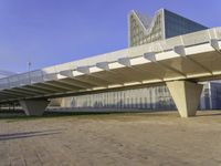 an elevated walkway over looking the city skyline at sunset is shown in this picture that features architecture