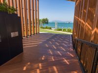 a large wooden walkway with wooden slats and metal railings leading to the deck