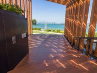 a large wooden walkway with wooden slats and metal railings leading to the deck