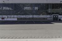 an airplane parked in a large, empty airport parking lot with glass walls and a sign saying we are not here