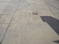 an airport runway and the control tower are empty, as seen from above the plane
