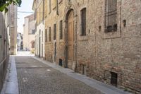 the alley is empty in this old european country town, while the people are walking up and down it