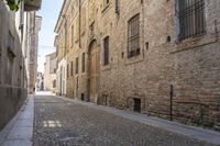 the alley is empty in this old european country town, while the people are walking up and down it