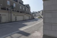 a long side walk in a town that is empty and closed with concrete panels between the sides