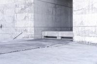 there is a empty bench outside of an old building with concrete walls and cement flooring