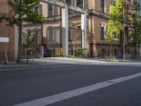 the street is empty of cars, motorcycles, and buildings in front of them in europe