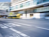 a blurry picture of an empty street with cars on it and buildings in the background