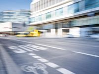 a blurry picture of an empty street with cars on it and buildings in the background