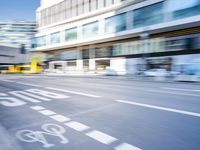 a blurry picture of an empty street with cars on it and buildings in the background