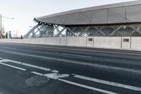 the bike path next to the building is empty while others travel through the frame of the building