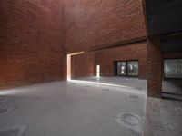 there is an empty brick building with some windows in it's roof area and light shining through the brick doorways