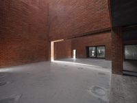 there is an empty brick building with some windows in it's roof area and light shining through the brick doorways