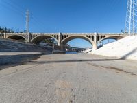 the roadway and bridge in the city is empty with no vehicles around it, including the two