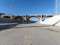 the roadway and bridge in the city is empty with no vehicles around it, including the two