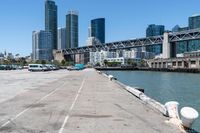 the bridge on a road looks empty in this urban setting with a city in the background