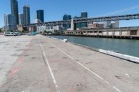 the bridge on a road looks empty in this urban setting with a city in the background