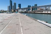 the bridge on a road looks empty in this urban setting with a city in the background