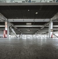 the view looking up from the inside of an empty building filled with concrete pillars and floors