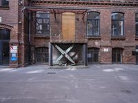 an empty building in a brick city with an open air door that is under construction