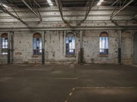 empty building with two double doors and multiple windows in the middle of the floor and another part of it inside