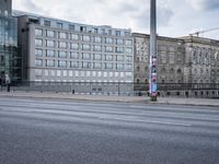 street in front of the building with an empty sign on it near an empty road