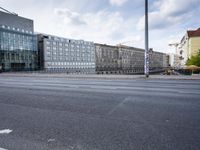 street in front of the building with an empty sign on it near an empty road